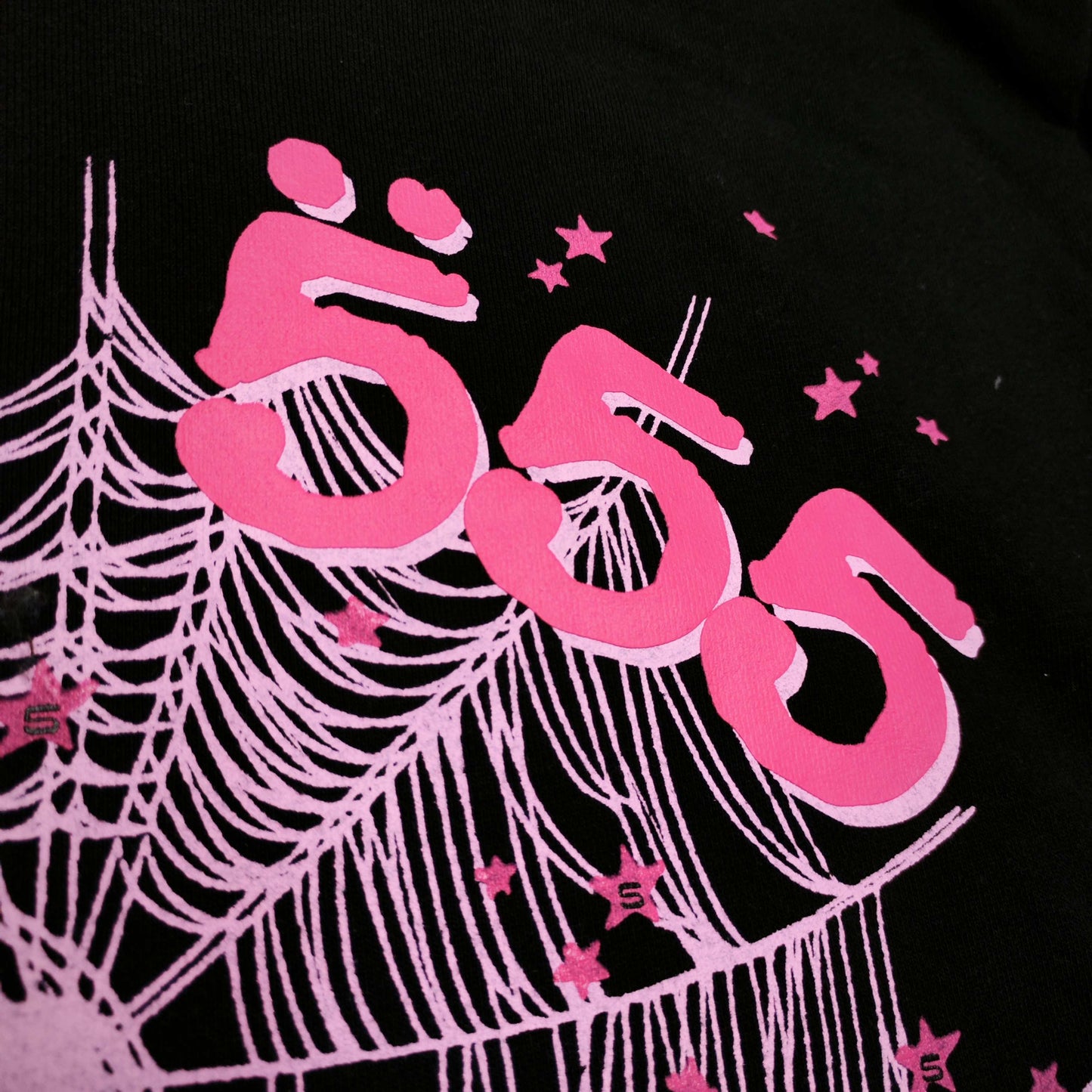 Full front artwork on Sp5der Angel Number Hoodie Black with pink 555 puff print and spider web
Close-up of raised pink 555 puff-print lettering on Sp5der Angel Number Hoodie Black
Side angle showing the three-dimensional pink puff-print texture on Sp5der Angel Number Hoodie
Close-up of pink OG spider-web artwork on Sp5der Angel Number Hoodie Black
