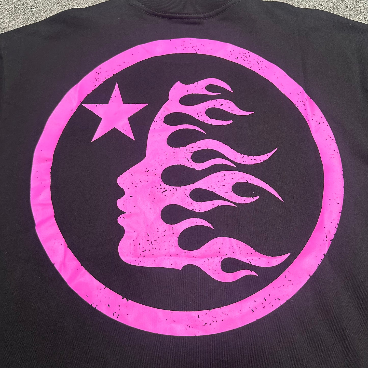 Hellstar Classic Rhinestone Logo T-Shirt black back view showing the rear graphic design
Full pink Hellstar logo graphic with rhinestone detailing on the chest of the black T-shirt
Detailed view of the logo print texture and edge finish on the Hellstar black pink graphic T-shirt