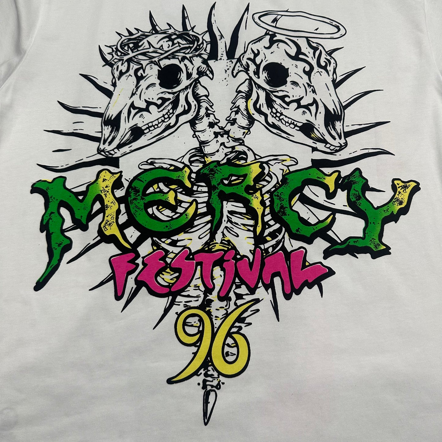 Close-up of the colorful front graphic on Hellstar Online white T-shirt
Detailed black outlines neon colors and paint splatter print on Hellstar Online graphic Tee
Neon pink flame cross graphic detail on Hellstar Online white T-shirt
Bright green flame graphic detail on Hellstar Online white streetwear T-shirt
Black paint splatter print detail on Hellstar Online white graphic T-shirt