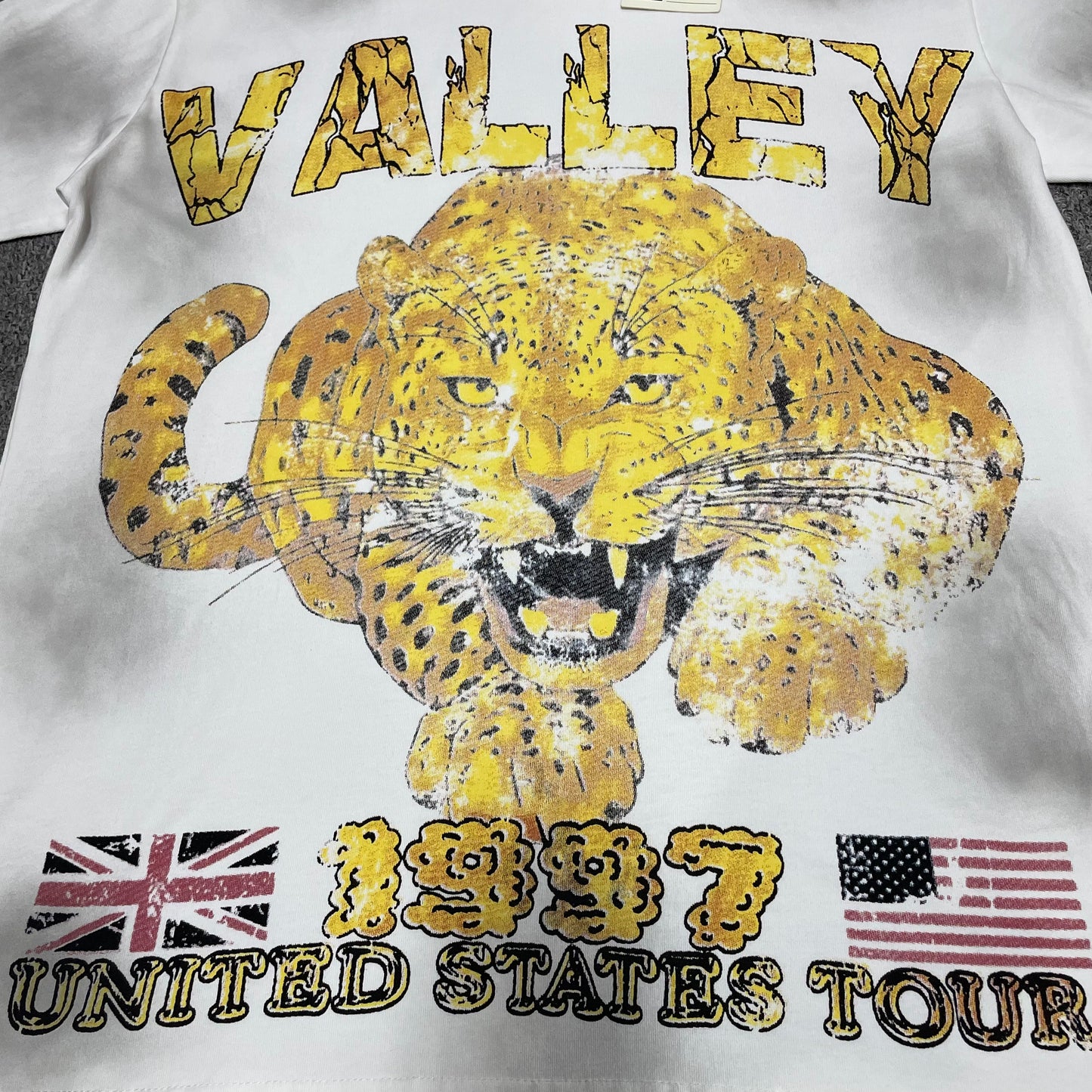 Vale Forever Cheetah Tee full 1997 United States Tour front graphic
Vale Forever Cheetah Tee oversized yellow wild-cat graphic
Vale Forever Cheetah Tee distressed vintage graphic print close-up
Vale Forever Cheetah Tee cracked yellow Valley lettering detail
Vale Forever Cheetah Tee distressed 1997 graphic detail
Vale Forever Cheetah Tee distressed UK and USA flag print detail
Vale Forever Cheetah Tee United States Tour lettering detail