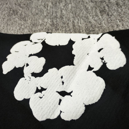 Black Cotton Wreath Hoodie with all-over white puff print
Close-up of white Cotton Wreath puff print on Black hoodie
Raised 3D Cotton Wreath puff print texture on Black hoodie