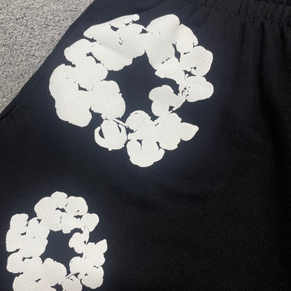 Black Cotton Wreath Sweatshorts with all-over white puff print
Close-up of white Cotton Wreath puff print on Black sweatshorts
Raised 3D Cotton Wreath puff print texture on Black sweatshorts