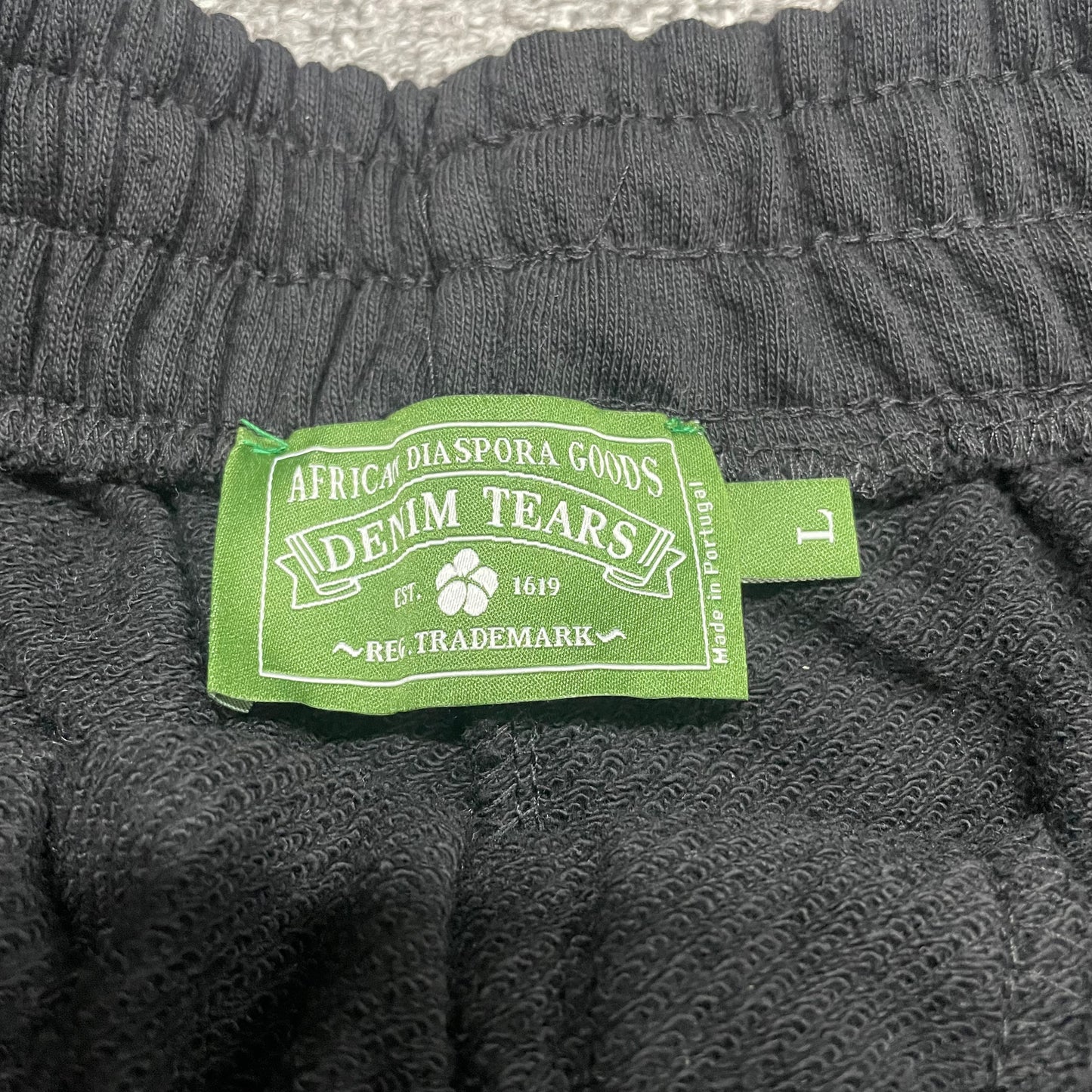 Black Cotton Wreath Sweatshorts care label and fabric information
Denim Tears Cotton Wreath Sweatshorts Black inner waistband label