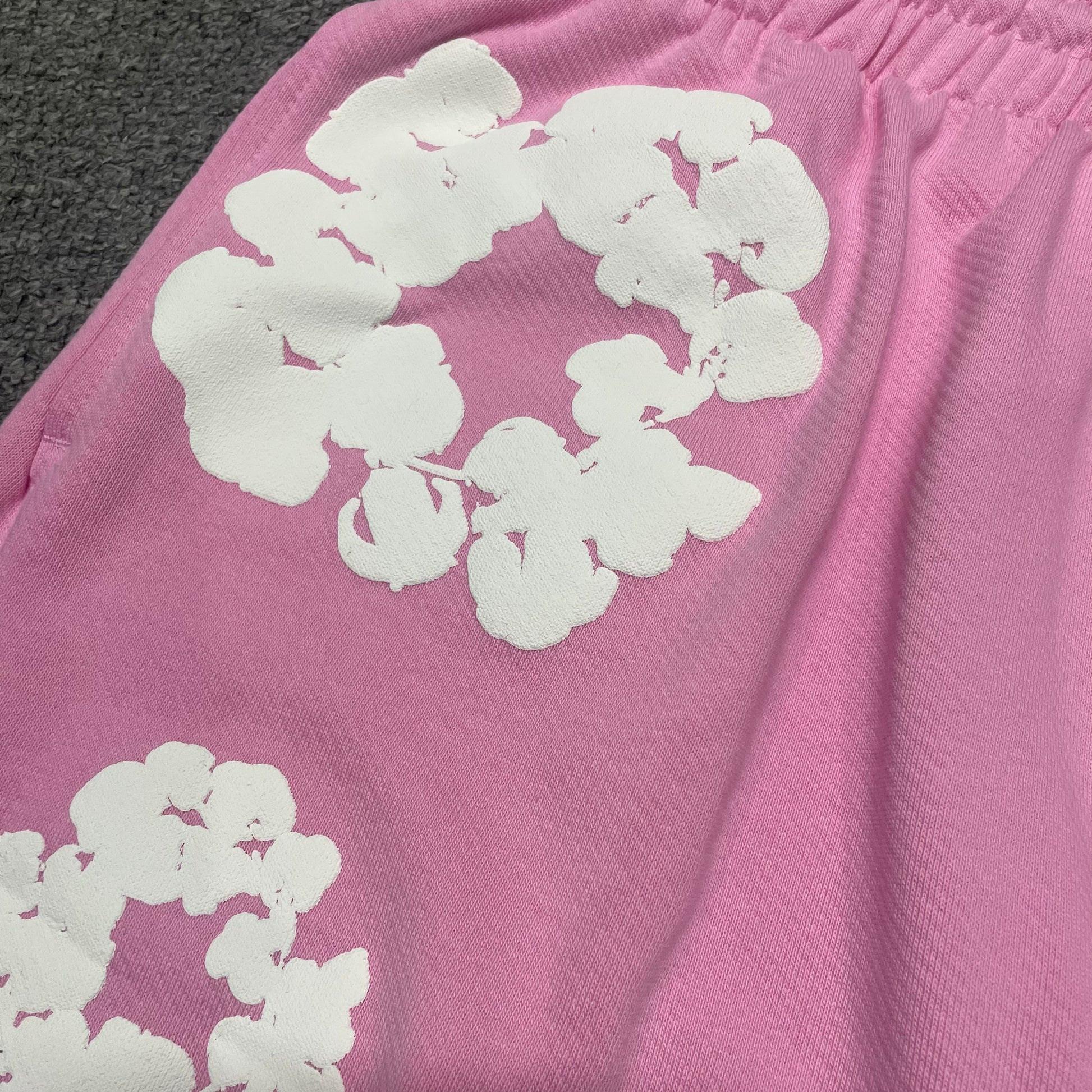 Powder Pink Cotton Wreath Sweatshorts with all-over white puff print
Close-up of white Cotton Wreath puff print on Powder Pink sweatshorts
Raised 3D Cotton Wreath puff print texture on Powder Pink sweatshorts