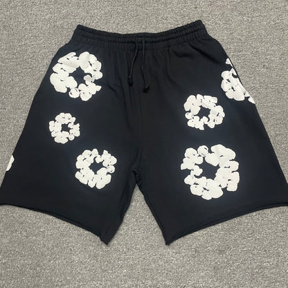 Black Cotton Wreath Sweatshorts with all-over white puff print
Close-up of white Cotton Wreath puff print on Black sweatshorts
Raised 3D Cotton Wreath puff print texture on Black sweatshorts