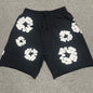 Black Cotton Wreath Sweatshorts with all-over white puff print
Close-up of white Cotton Wreath puff print on Black sweatshorts
Raised 3D Cotton Wreath puff print texture on Black sweatshorts
