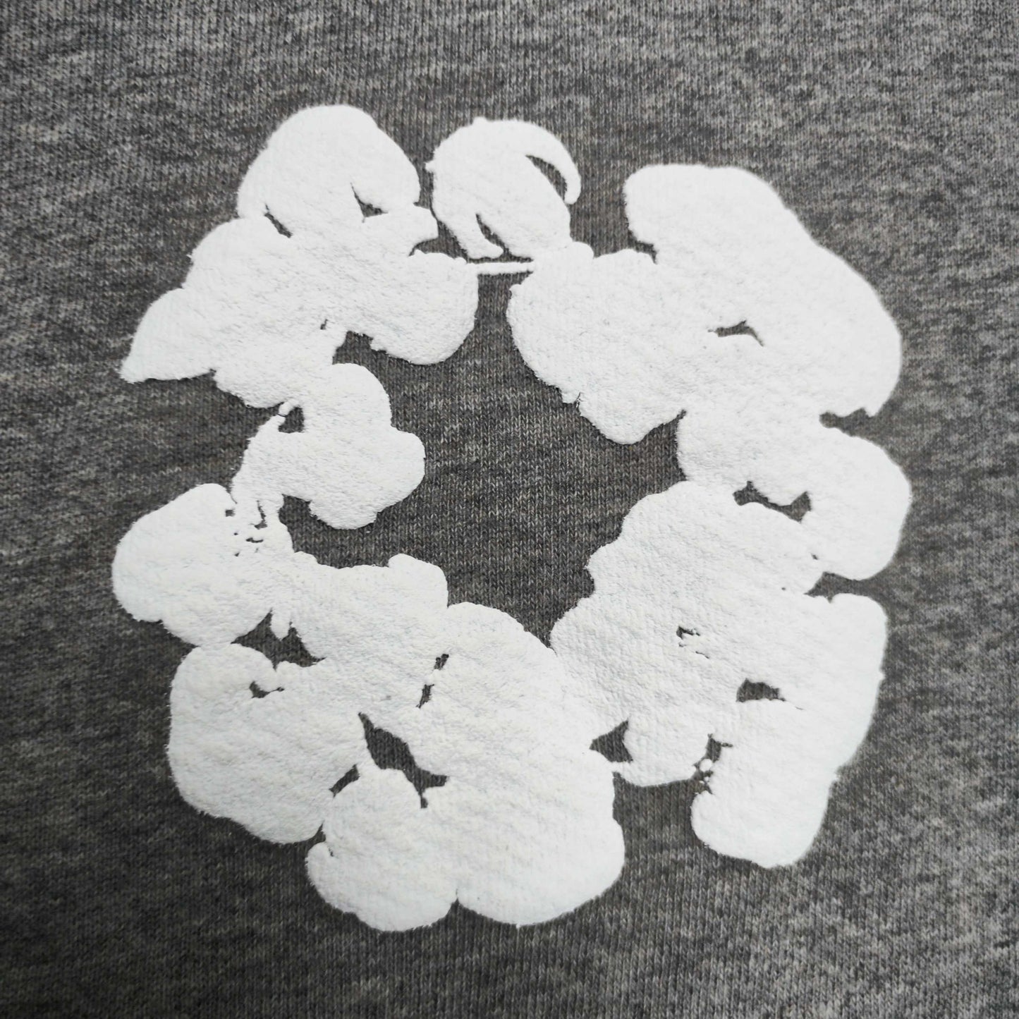 Grey Cotton Wreath Hoodie with all-over white puff print
Close-up of white Cotton Wreath puff print on Grey hoodie
Raised 3D Cotton Wreath puff print texture on Grey hoodie