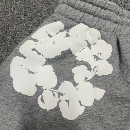 Grey Cotton Wreath Sweatshorts with all-over white puff print
Close-up of white Cotton Wreath puff print on Grey sweatshorts
Raised 3D Cotton Wreath puff print texture on Grey sweatshorts