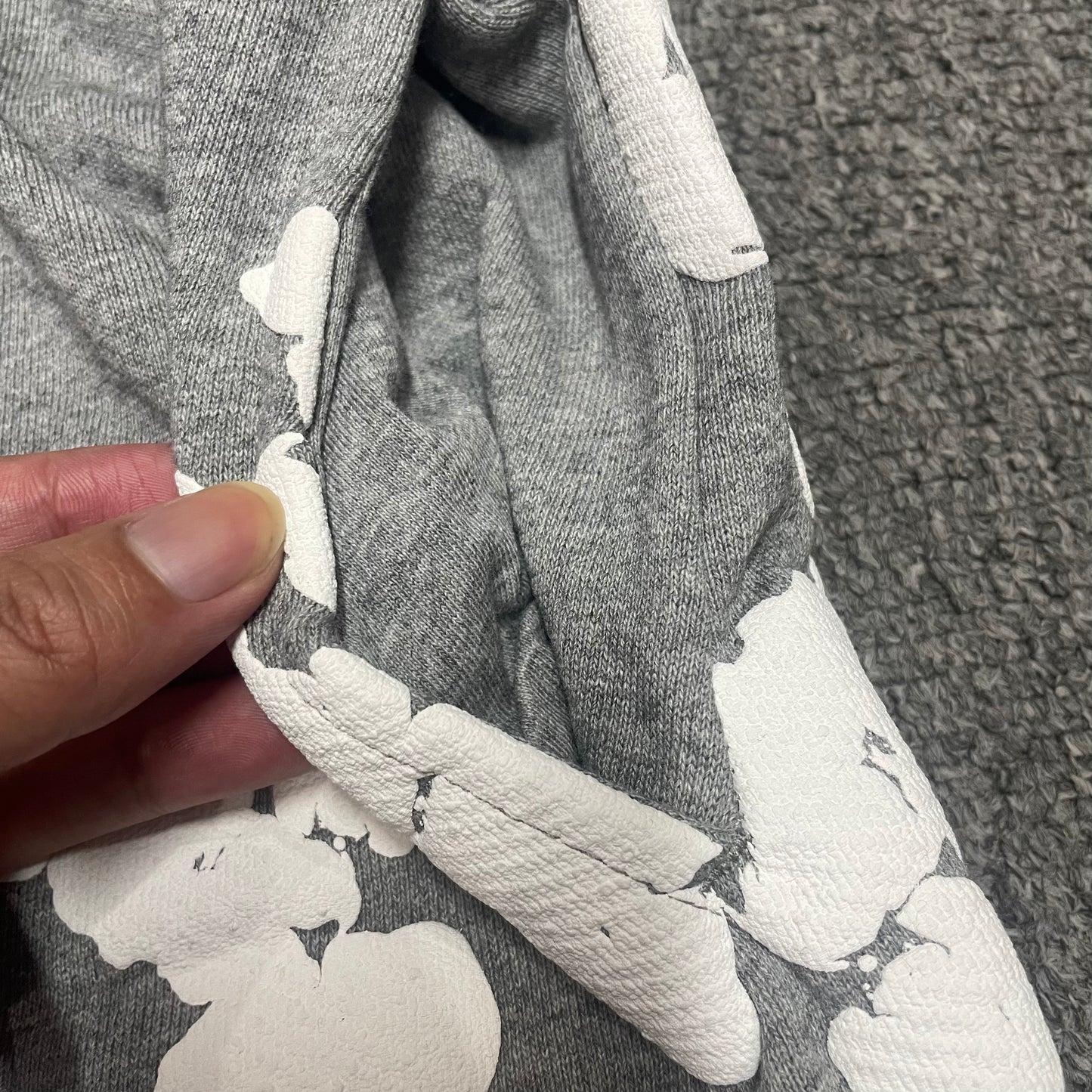 Grey Cotton Wreath Sweatshorts with all-over white puff print
Close-up of white Cotton Wreath puff print on Grey sweatshorts
Raised 3D Cotton Wreath puff print texture on Grey sweatshorts