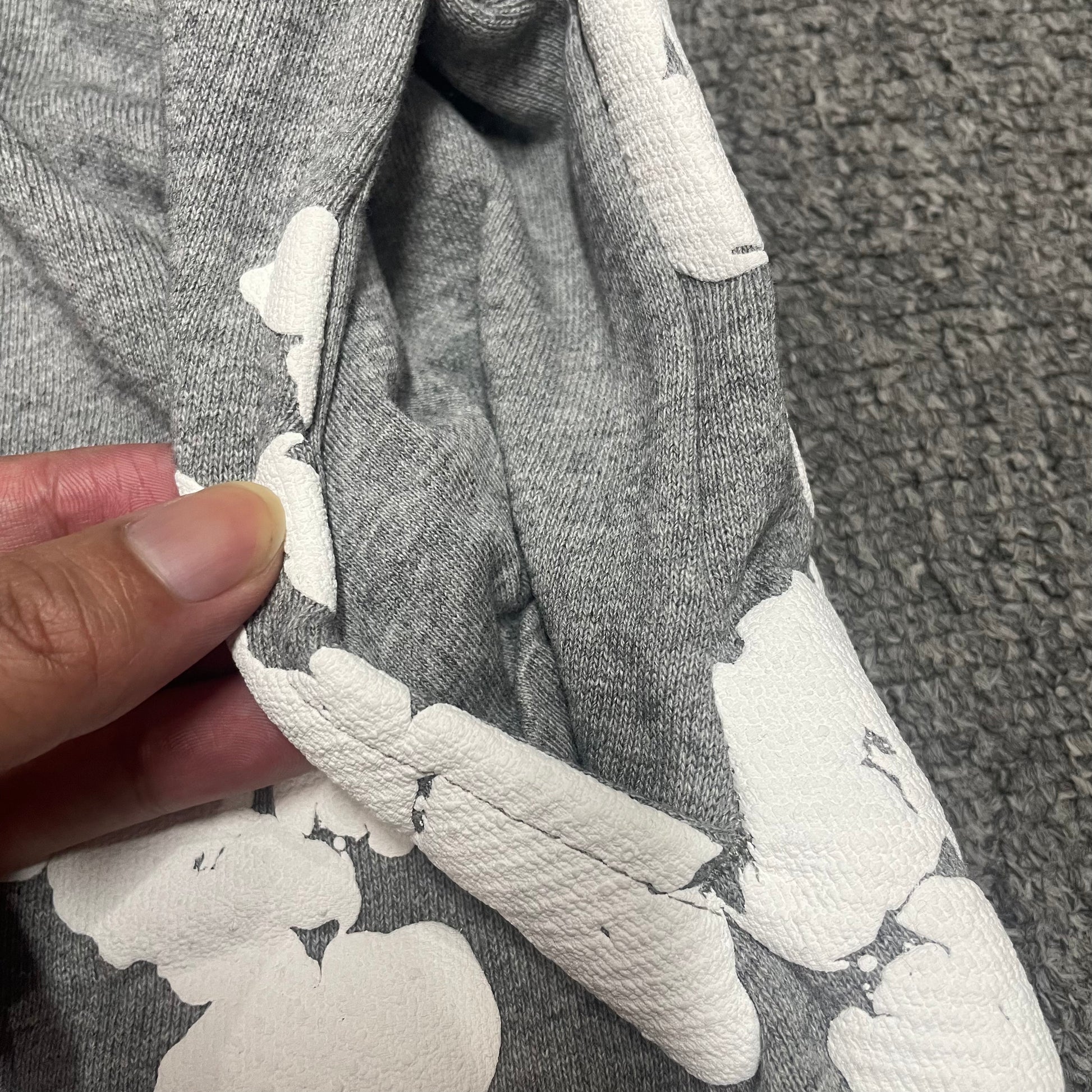 Grey Cotton Wreath Sweatshorts with all-over white puff print
Close-up of white Cotton Wreath puff print on Grey sweatshorts
Raised 3D Cotton Wreath puff print texture on Grey sweatshorts