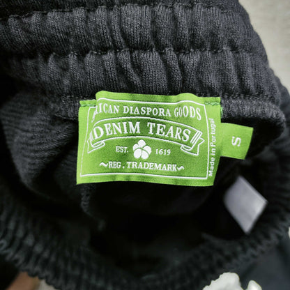 Denim Tears Cotton Wreath Sweatpants Black inner waistband label
Black Cotton Wreath Sweatpants care label and fabric information