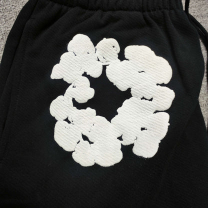 Black Cotton Wreath Sweatpants with all-over white puff print
Close-up of white Cotton Wreath puff print on Black sweatpants
Raised 3D Cotton Wreath puff print texture on Black sweatpants