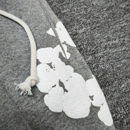 Heather Grey Cotton Wreath Sweatpants with all-over white puff print
Close-up of white Cotton Wreath puff print on Heather Grey sweatpants
Raised 3D Cotton Wreath puff print texture on Heather Grey sweatpants