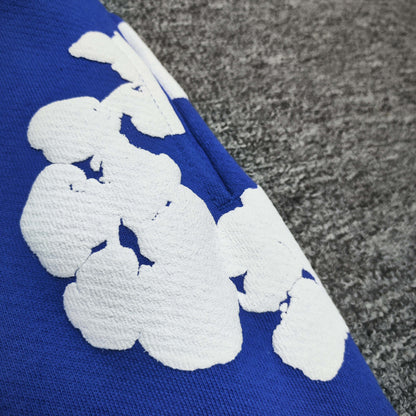 Royal Blue Cotton Wreath Sweatpants with all-over white puff print
Close-up of white Cotton Wreath puff print on Royal Blue sweatpants
Raised 3D Cotton Wreath puff print texture on Royal Blue sweatpants