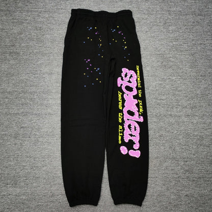 Sp5der P*NK sweatpants black front view with pink rhinestone logo and multicolor star graphics