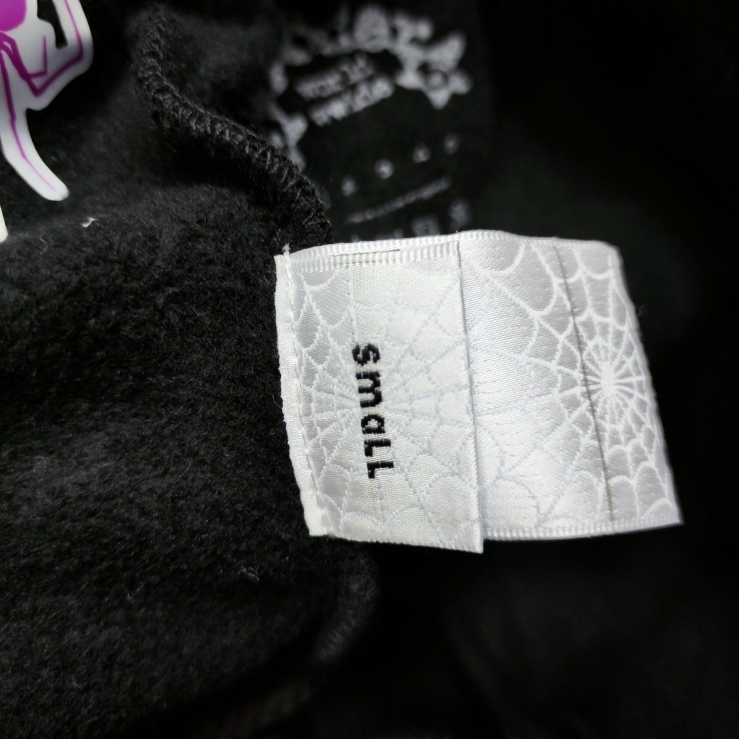 Sp5der P*NK sweatpants care label and washing instructions