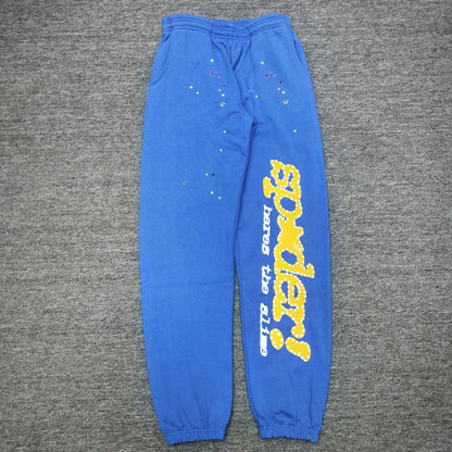 SP5DER TC Blue sweatpants front view with yellow leg graphic and multicolor star details
