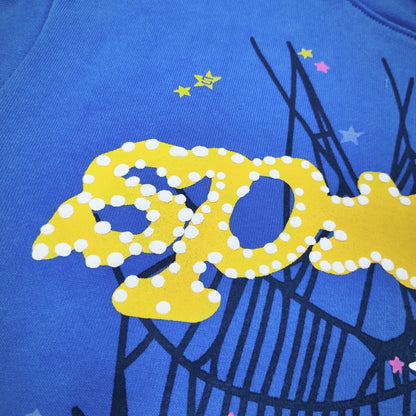 Full puff print artwork on Sp5der TC Blue Hoodie with yellow lettering, black spider web and colorful stars
Close-up of yellow raised puff lettering on Sp5der TC Blue Here's the Slime Hoodie
Side angle showing the three-dimensional raised puff print texture on Sp5der TC Blue Hoodie