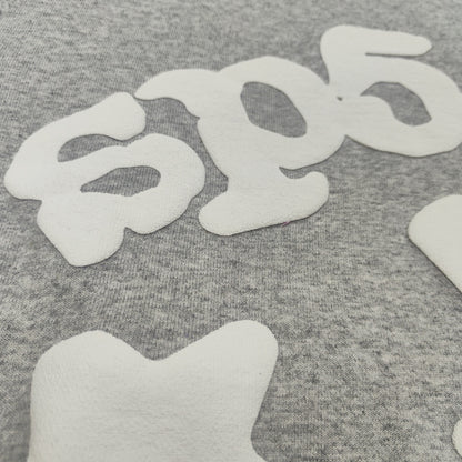 Full white puff-print artwork on Sp5der Beluga Hoodie Heather Grey with oversized logo and stars
Close-up of white puff-print lettering and star graphics on Sp5der Beluga Hoodie Heather Grey
Side angle showing the raised three-dimensional puff-print texture on Sp5der Beluga Hoodie