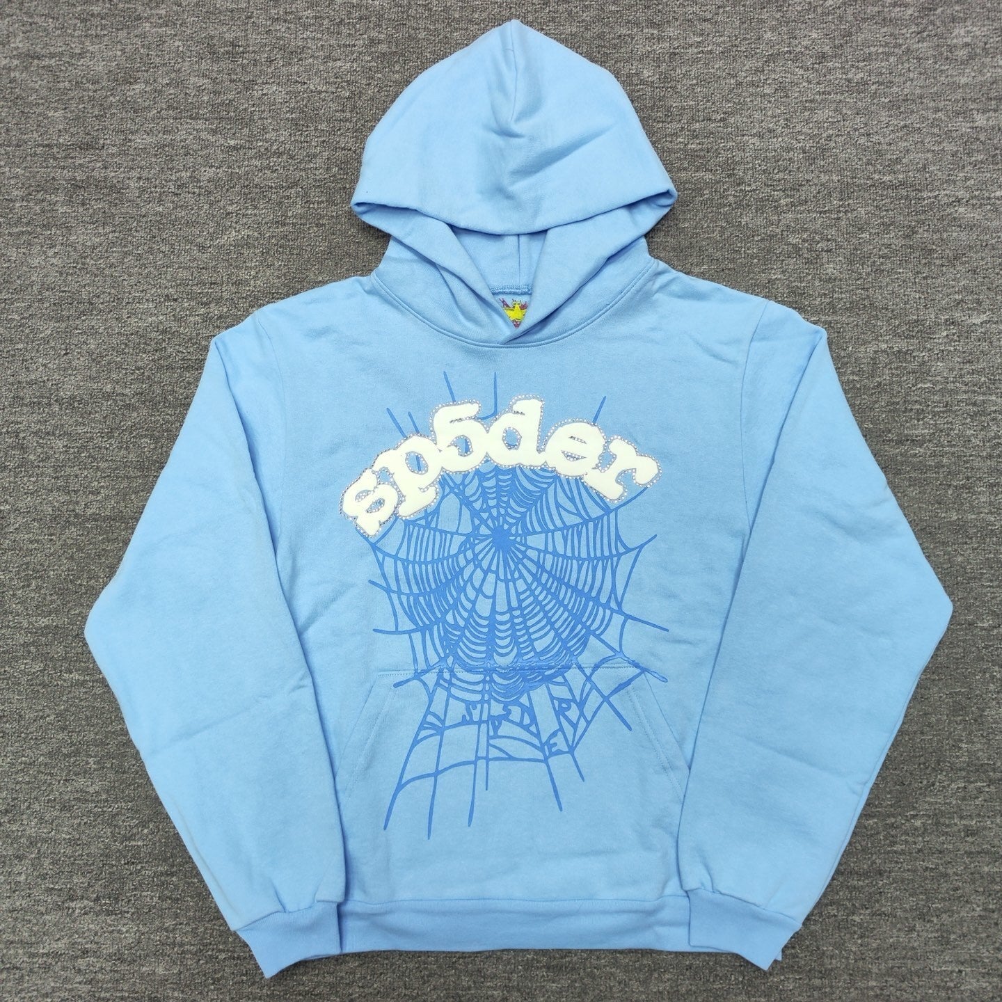 Sp5der Web Hoodie Sky Blue front view with raised white logo, rhinestone trim and blue web graphic