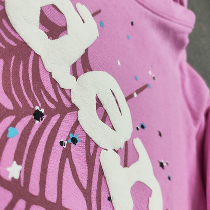 Full puff-print artwork on Sp5der OG Web Hoodie Pink with white logo, spider web and scattered stars
Close-up of raised white Sp5der lettering and star print details on the pink OG Web Hoodie
Side angle showing the raised three-dimensional puff-print texture on Sp5der OG Web Hoodie Pink