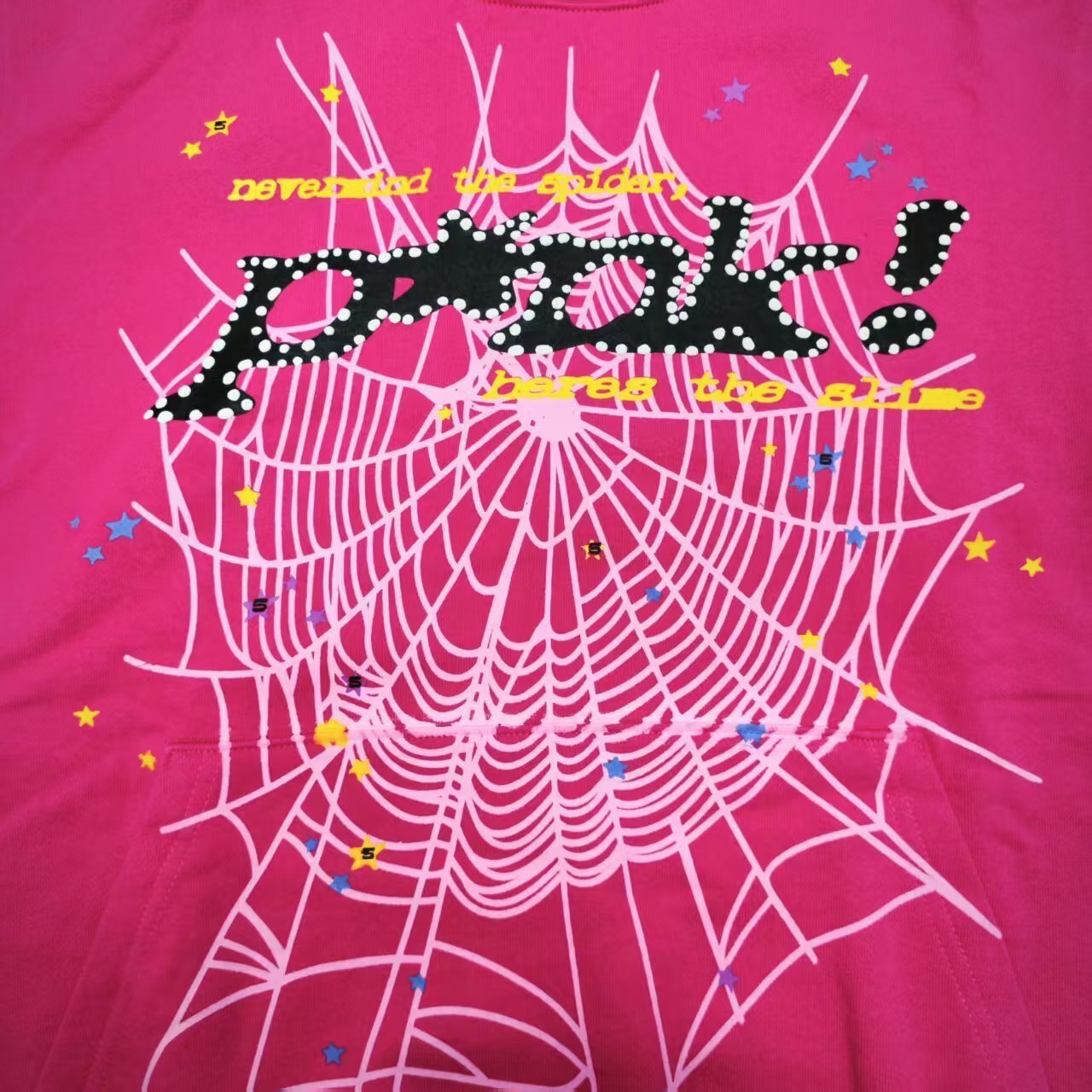 Full graphic artwork on Sp5der P*NK Hoodie Pink with black logo, white web and colorful stars
Close-up of black P*NK lettering with white dot trim on Sp5der Pink Hoodie
Side angle showing the raised three-dimensional graphic texture on Sp5der P*NK Hoodie Pink
