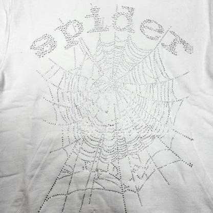 Full rhinestone artwork on Sp5der OG Logo Hoodie White with crystal lettering and spider web
Close-up of silver rhinestone Sp5der lettering and crystal web details on the white hoodie
Side angle showing the raised three-dimensional rhinestone texture on Sp5der White Hoodie