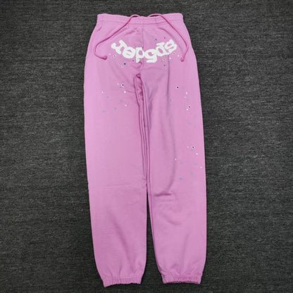 SP5DER Atlanta pink sweatpants front view with white logo and scattered star graphics