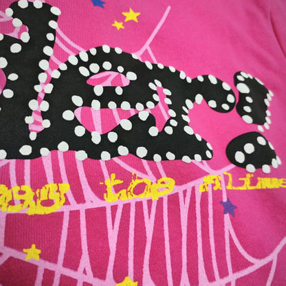 Full puff-print artwork on Sp5der P*NK V2 Hoodie Pink with black logo, white web and stars
Close-up of raised black SP5DER lettering with white dot details on the pink V2 hoodie
Side angle showing the three-dimensional puff-print texture on Sp5der P*NK V2 Hoodie Pink