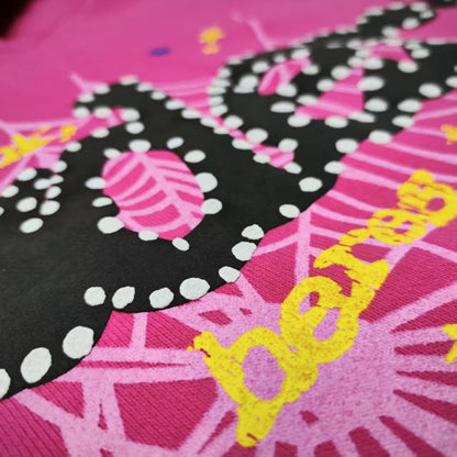 Full puff-print artwork on Sp5der P*NK V2 Hoodie Pink with black logo, white web and stars
Close-up of raised black SP5DER lettering with white dot details on the pink V2 hoodie
Side angle showing the three-dimensional puff-print texture on Sp5der P*NK V2 Hoodie Pink