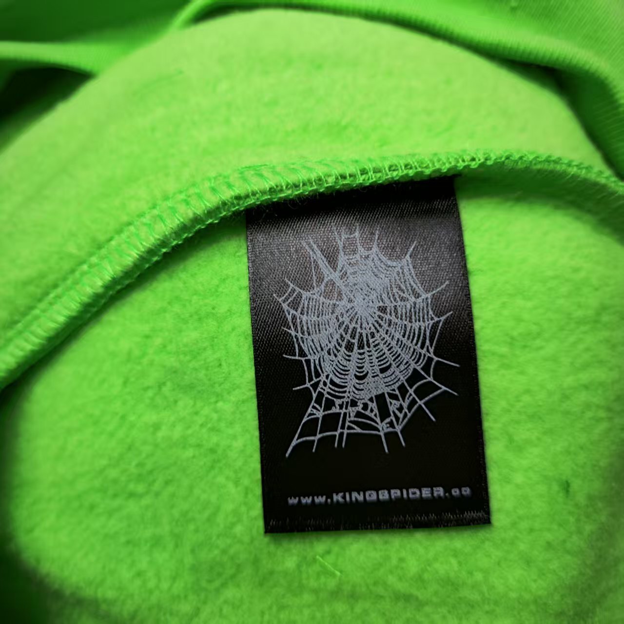 Sp5der Web Hoodie Slime Green neck label and size tag detail
Sp5der Web Hoodie Slime Green care label and washing instruction detail