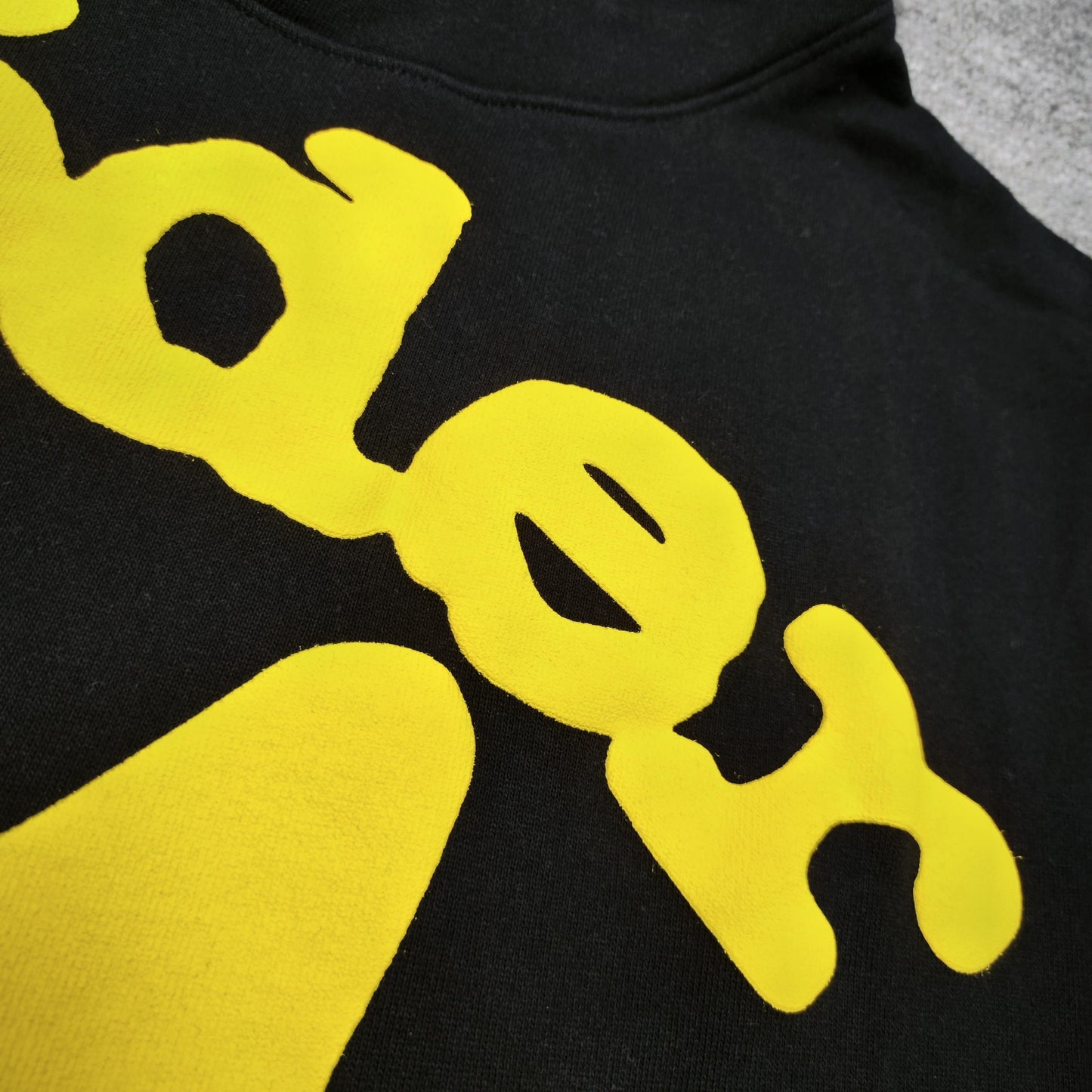 Full yellow puff-print artwork on Sp5der Beluga Hoodie Onyx Yellow with logo and star graphics
Close-up of raised yellow Sp5der lettering and smooth puff-print edges on the black Beluga Hoodie
Side angle showing the three-dimensional yellow puff-print texture on Sp5der Beluga Hoodie
Yellow star and number graphics printed across the sleeve of Sp5der Beluga Hoodie Onyx Yellow
