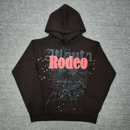 Travis Scott x Sp5der Days Before Rodeo Hoodie Brown front view with red RODEO lettering and gold stars