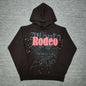 Travis Scott x Sp5der Days Before Rodeo Hoodie Brown front view with red RODEO lettering and gold stars