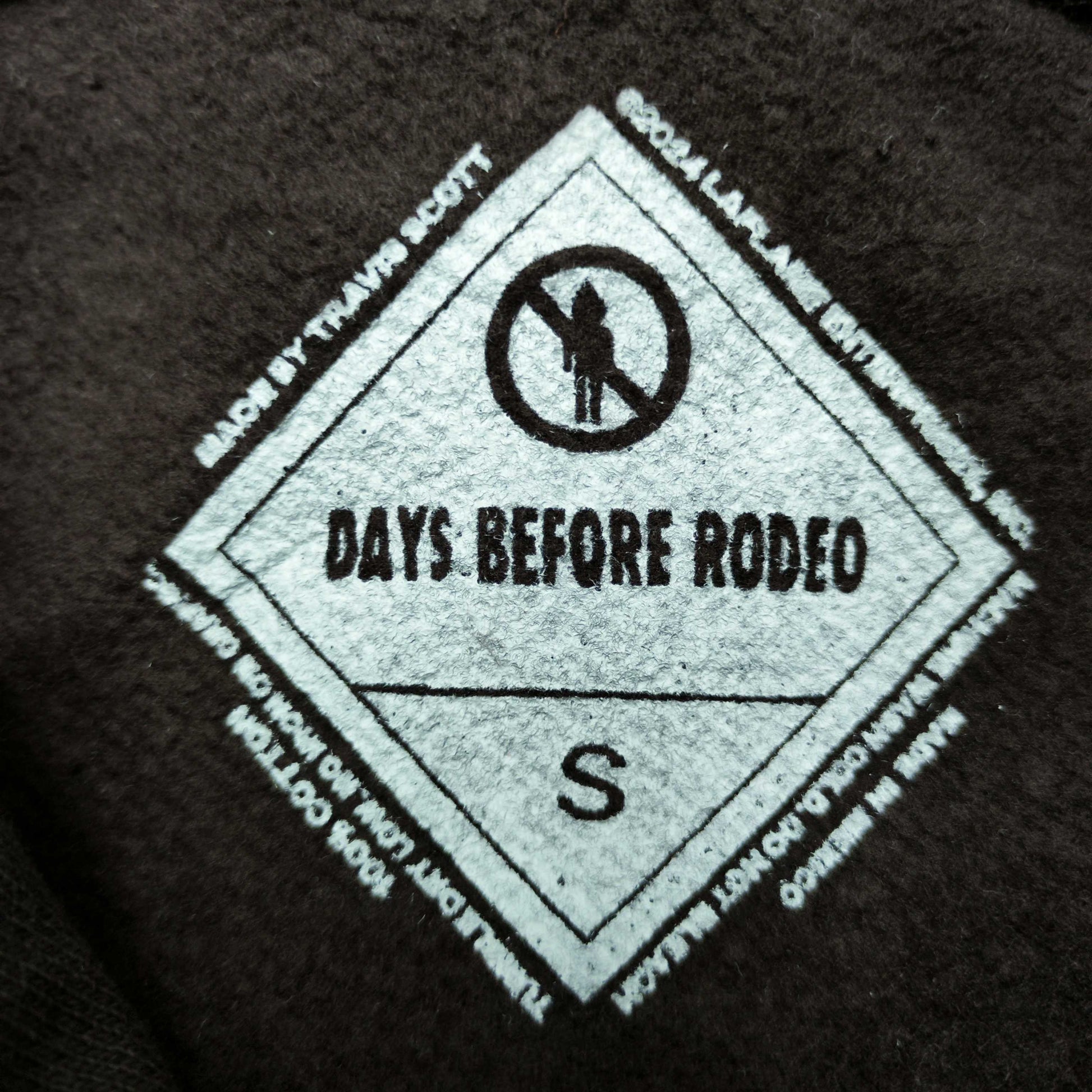 Travis Scott x Sp5der Days Before Rodeo Hoodie Brown neck label and size tag detail
Travis Scott x Sp5der Days Before Rodeo Hoodie Brown care label and washing instruction detail