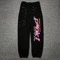 SP5DER P*NK V2 black sweatpants front view with pink leg graphic and multicolor stars