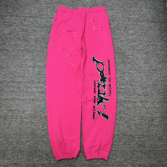 SP5DER P*NK V2 pink sweatpants front view with black leg graphic and multicolor stars