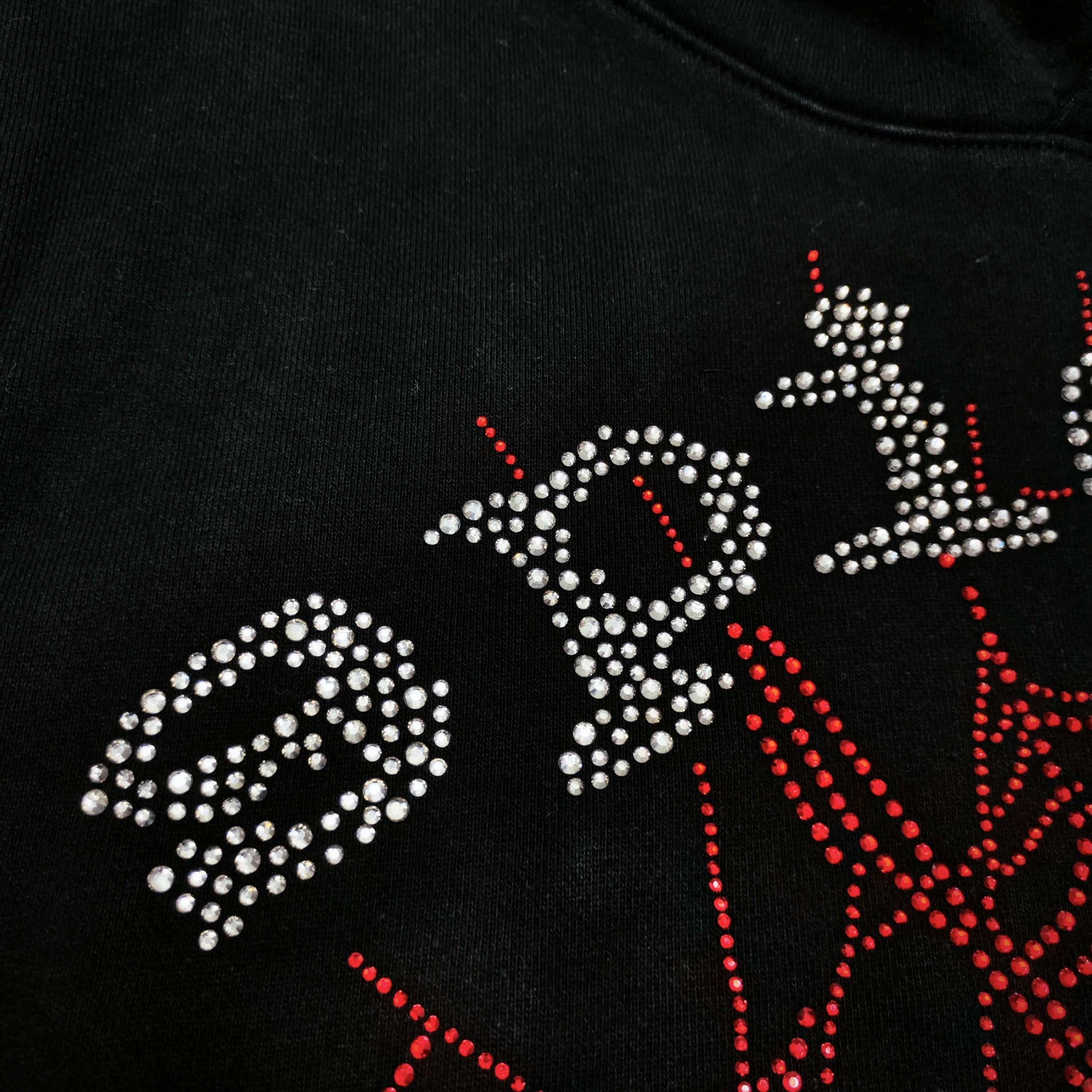 Full rhinestone artwork on Sp5der OG Web V2 Hoodie Black with silver logo and red spider web
Close-up of silver rhinestone SP5DER lettering on the black OG Web V2 Hoodie
Close-up of red rhinestone spider-web detailing on Sp5der OG Web V2 Hoodie Black
Side angle showing the raised three-dimensional rhinestone texture on Sp5der OG Web V2 Hoodie