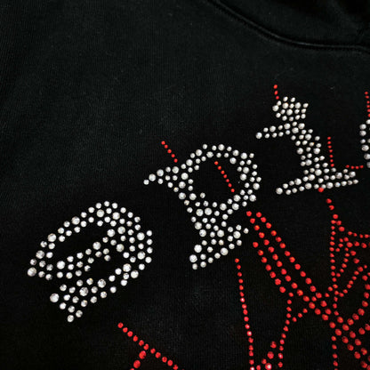 Full rhinestone artwork on Sp5der OG Web V2 Hoodie Black with silver logo and red spider web
Close-up of silver rhinestone SP5DER lettering on the black OG Web V2 Hoodie
Close-up of red rhinestone spider-web detailing on Sp5der OG Web V2 Hoodie Black
Side angle showing the raised three-dimensional rhinestone texture on Sp5der OG Web V2 Hoodie