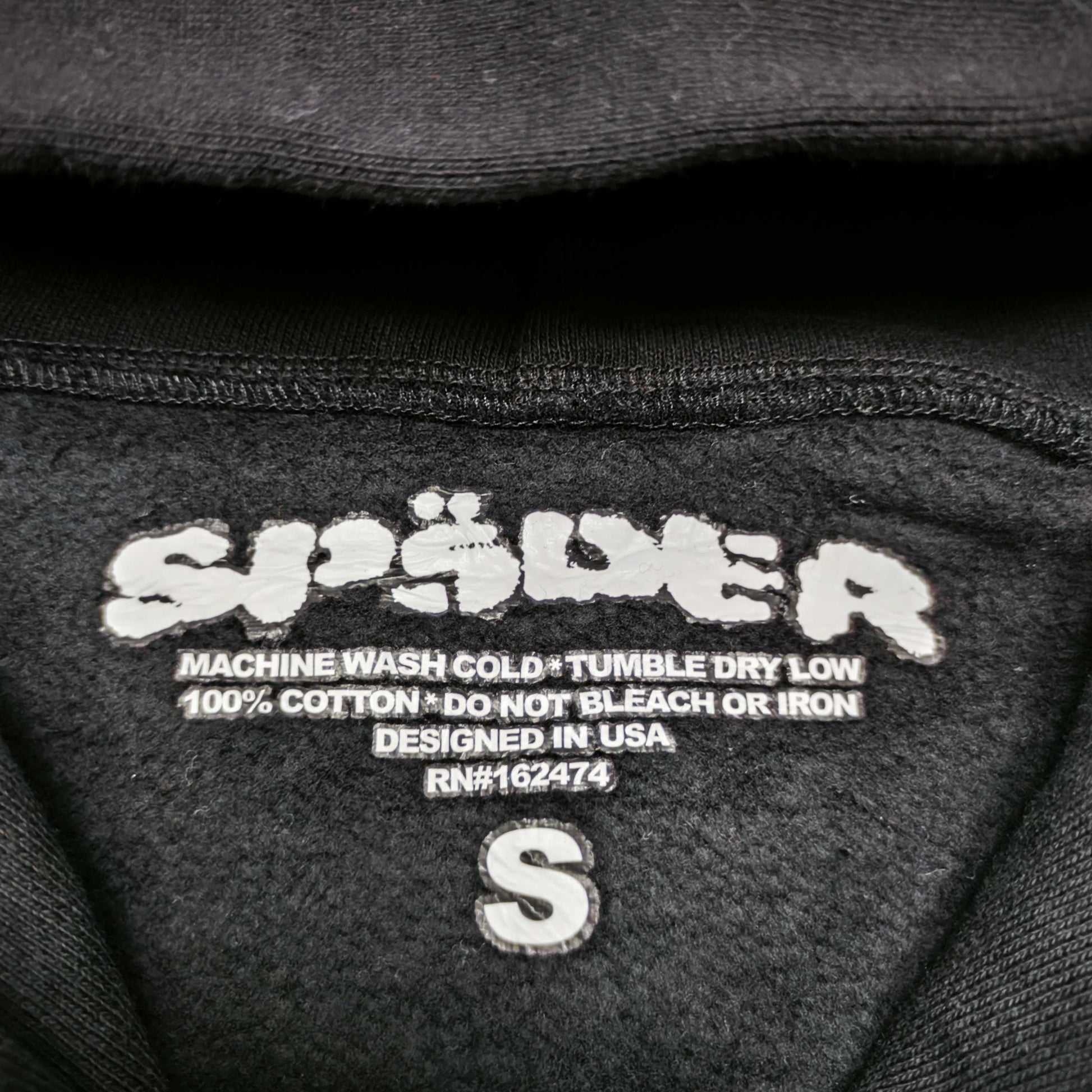 Sp5der Rhinestone OG Web V2 Hoodie Black neck label and size tag detail
Sp5der Rhinestone OG Web V2 Hoodie Black care label and washing instruction detail