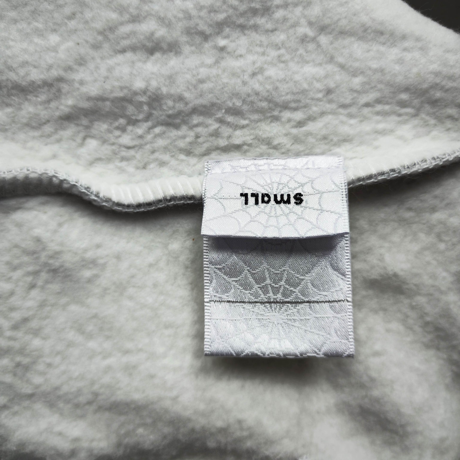 Sp5der OG Web Hoodie Heather Grey neck label and size tag detail
Sp5der OG Web Hoodie Heather Grey care label and washing instruction detail