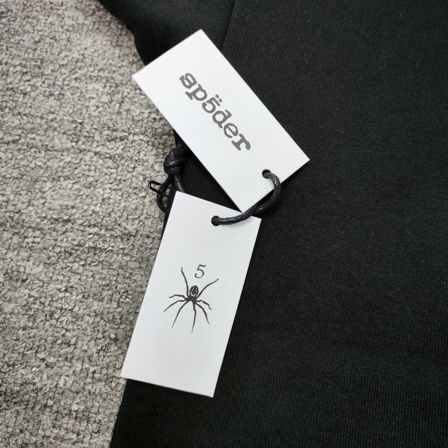 Sp5der Angel Number Hoodie Black neck label and size tag detail
Sp5der Angel Number Hoodie Black care label and washing instruction detail