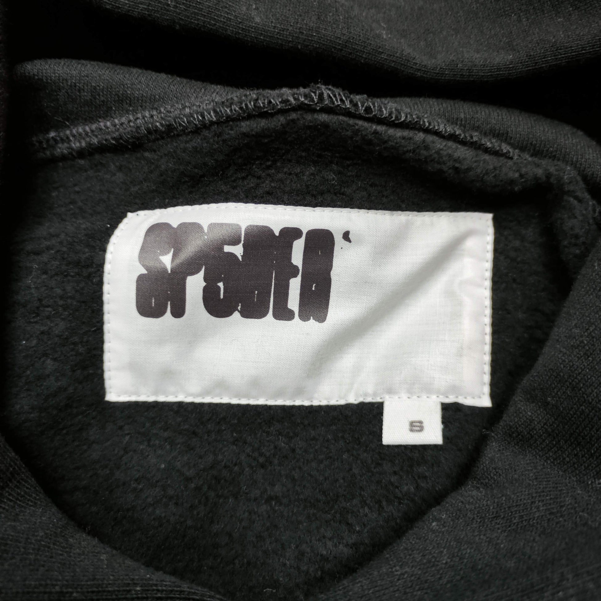 Sp5der OG Web Hoodie Black neck label and size tag detail
Sp5der OG Web Hoodie Black care label and washing instruction detail