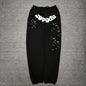 SP5DER OG Web black sweatpants front view with white logo and scattered star graphics