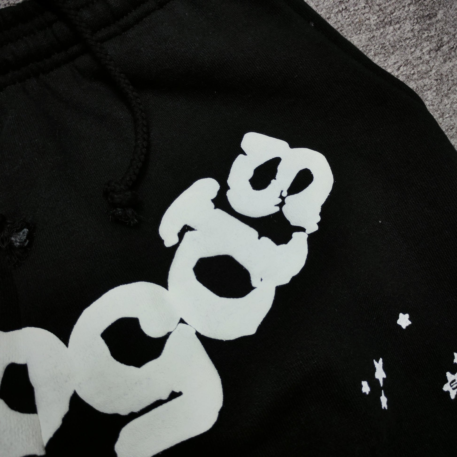 Close-up of defined puff-print edges on SP5DER OG Web sweatpants