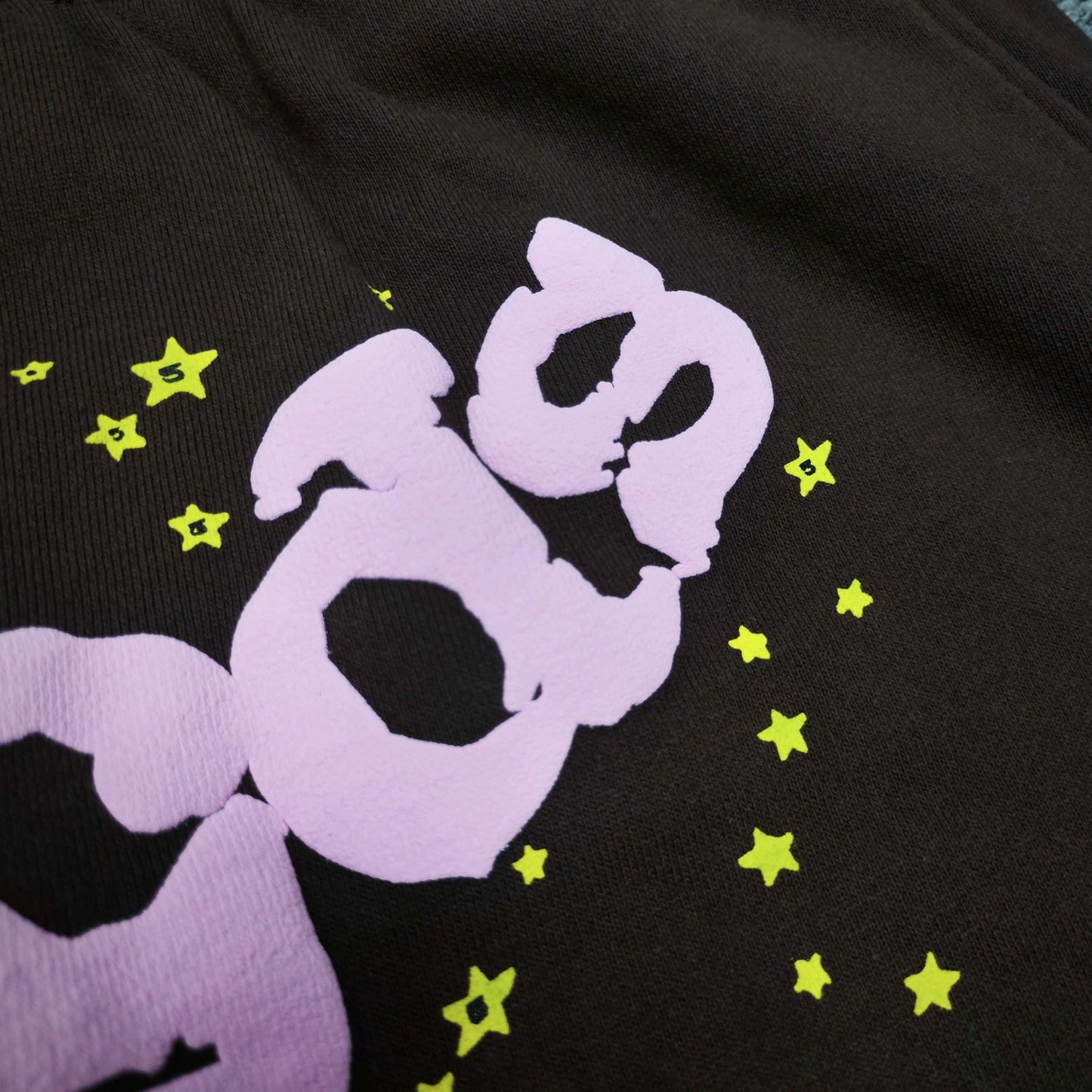 Close-up of defined puff-print edges on SP5DER Classic sweatpants