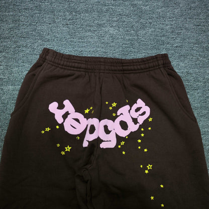 Pink inverted SP5DER logo and yellow star graphics on Classic brown sweatpants