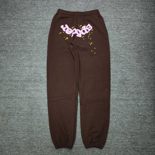 SP5DER Classic brown sweatpants front view with pink logo and yellow star graphics