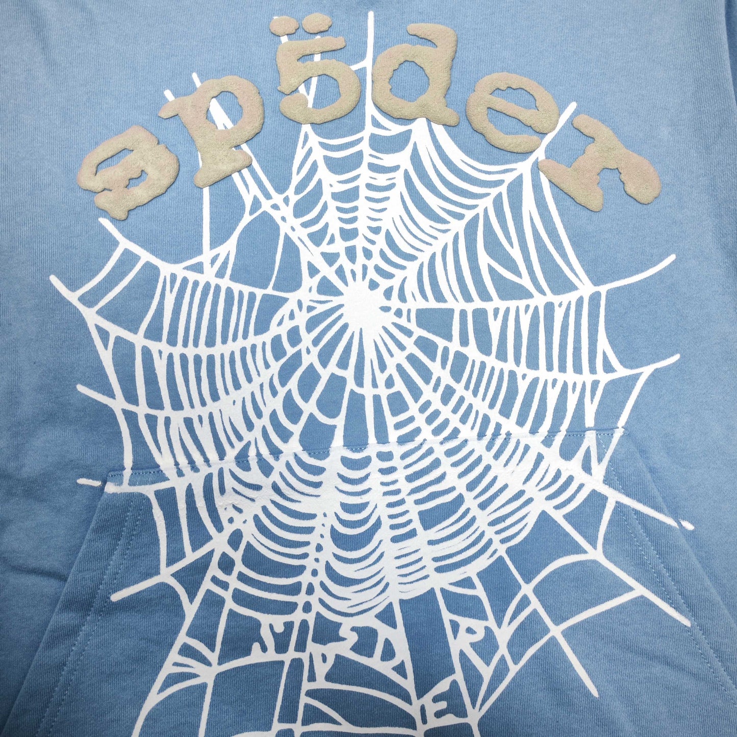 Full front artwork on Sp5der OG Web V2 Hoodie Dusty Blue with grey puff logo and white web
Close-up of raised grey SP5DER puff-print lettering on the Dusty Blue OG Web V2 Hoodie
Side angle showing the three-dimensional grey puff-print texture on Sp5der Dusty Blue Hoodie
Close-up of the white Web V2 spider-web graphic on Sp5der OG Hoodie Dusty Blue