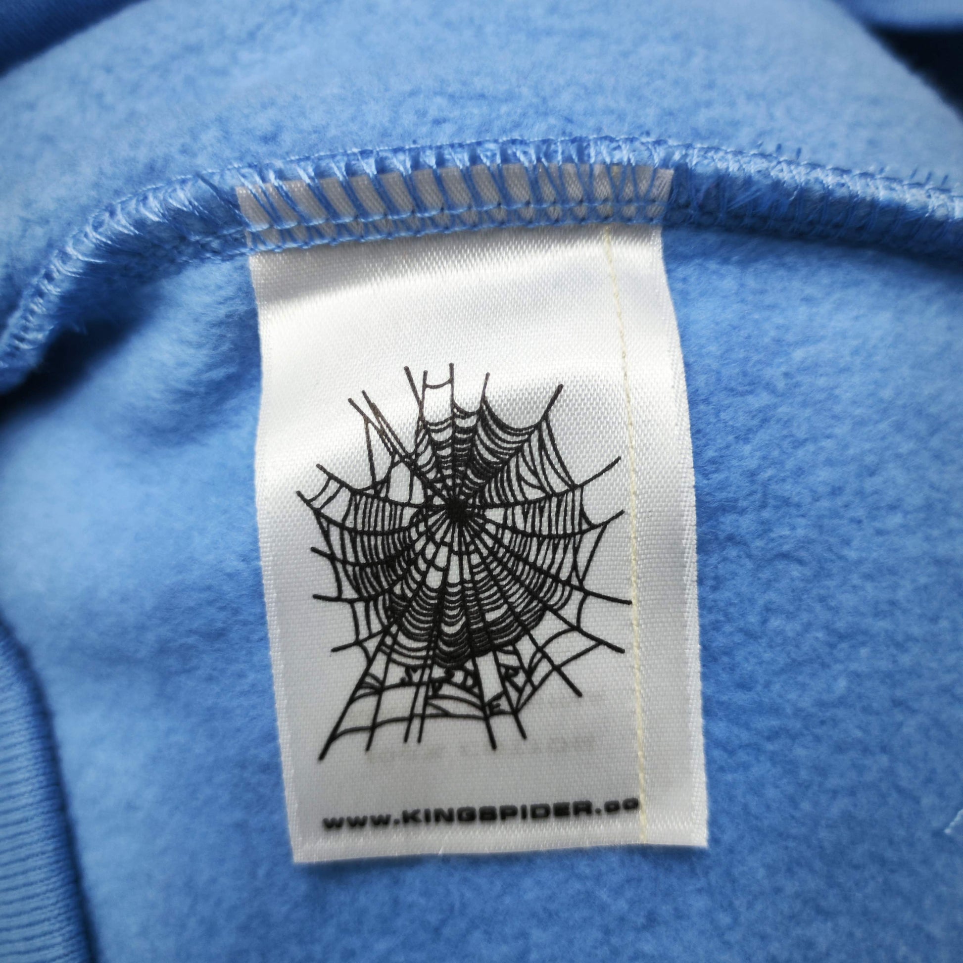 Sp5der OG Web V2 Hoodie Dusty Blue neck label and size tag detail
Sp5der OG Web V2 Hoodie Dusty Blue care label and washing instruction detail